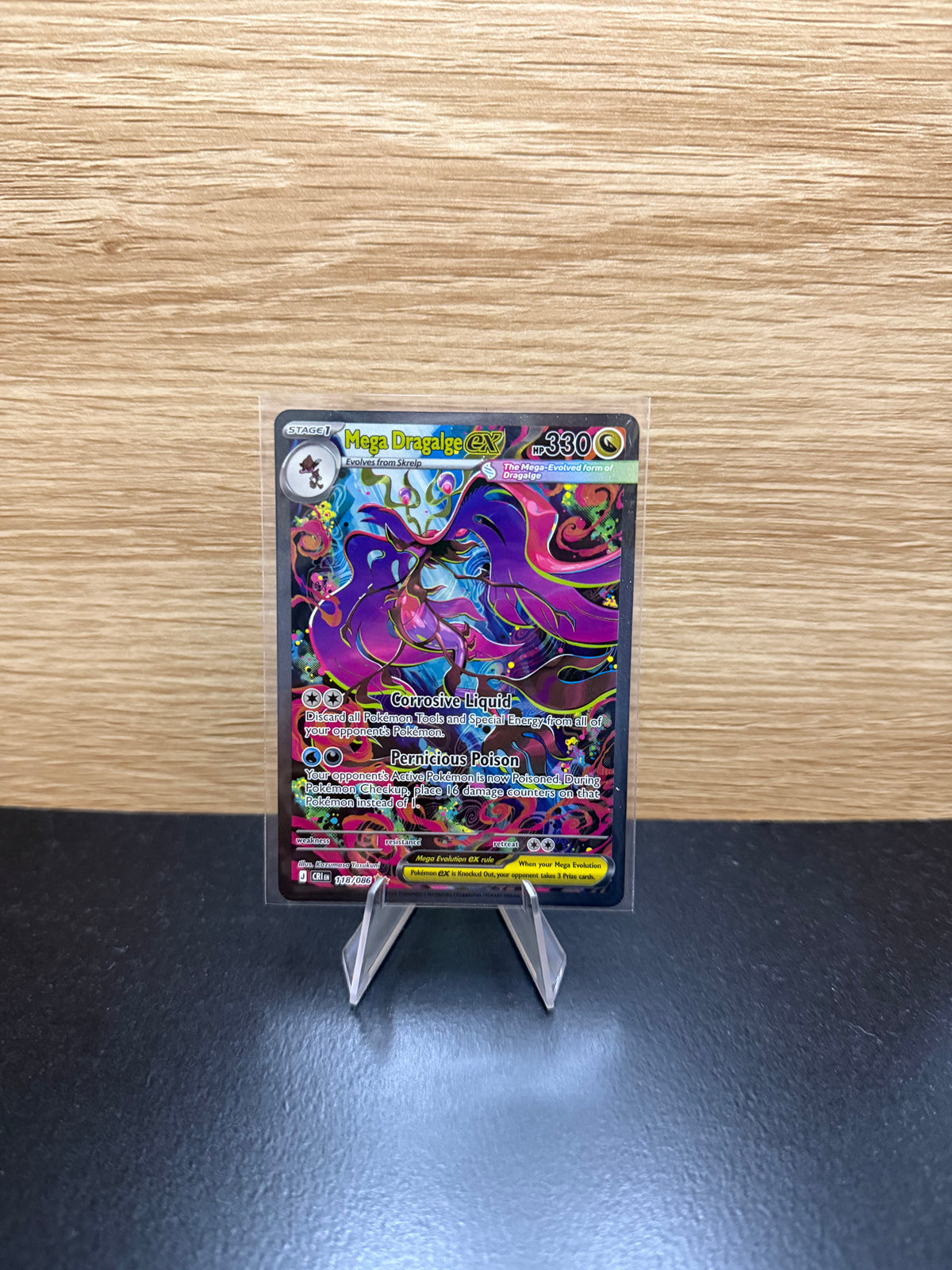 English Mega Dragalge ex Pokémon card displayed on a stand