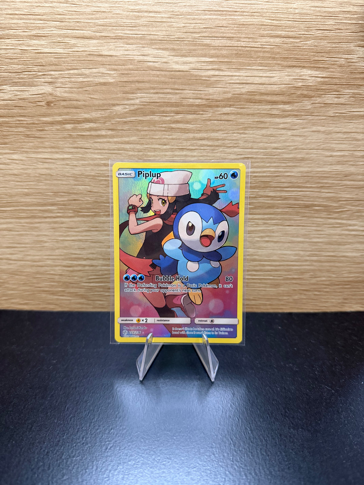English Piplup Pokémon card displayed on a stand